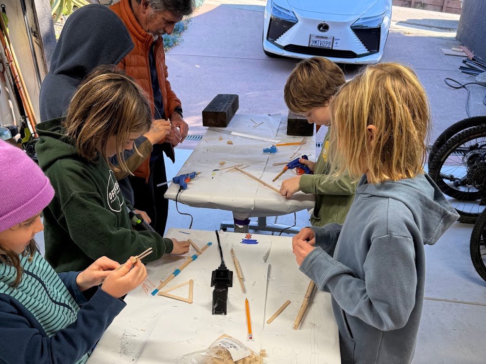 Kids testing hand-built truss bridges