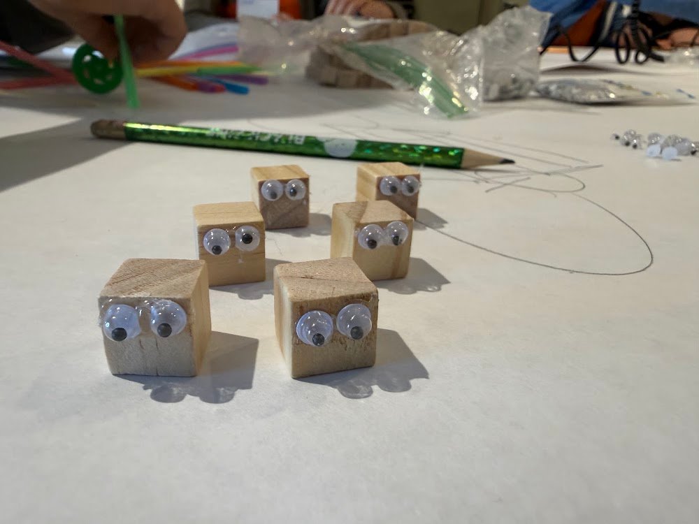 Wooden cubes with googly eyes, built during Downhill Racers